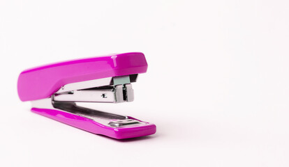 Pink stapler on a white background.