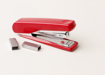 Red stapler on a white background.