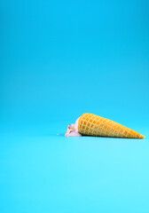 sweet potato flavor ice cream cone in a melting process on blue background vertical composition