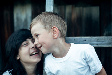 Fototapeta premium Small funny boy with sister, close-up portrait. The village children outdoors.