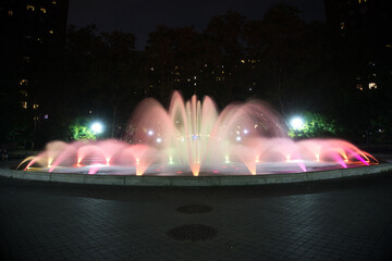 Red and orange colored water fountain at night