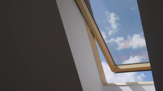 white cloud move on blue sky seen from open wooden attic widow, , fresh air in house, fast motion