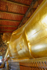 Fototapeta premium Wat Pho Buddhist Temple. Bangkok, Thailand. Every detail in the temple area, decorated with extraordinary decorations, is appreciated by all visitors.