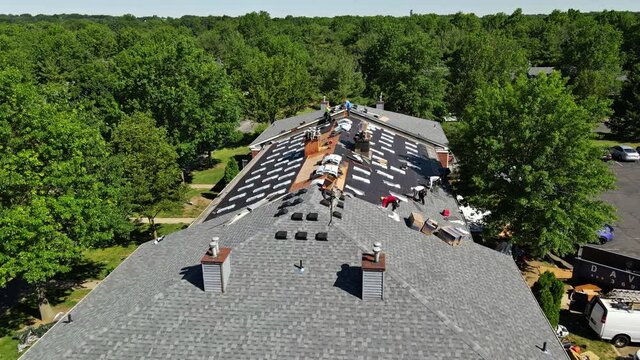 East Brunswick NJ US. 20 JUNE 2020: Roof repairs old roof replacement with new shingles of an apartment building