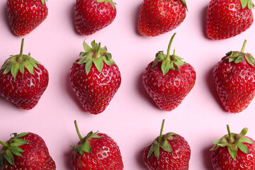 Tasty ripe strawberries on pink background, flat lay