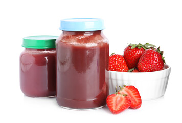 Jars with baby food and fresh strawberries on white background