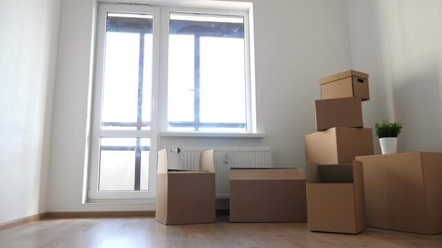 Packed household boxes for movement in empty room. Movement concept