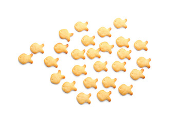 Delicious crispy goldfish crackers on white background, top view