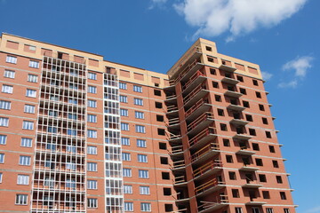 Naklejka premium construction of a modern multi-storey brick residential building with Windows