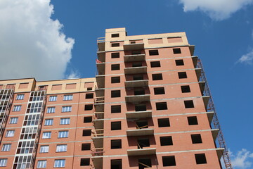 construction of a modern multi-storey brick residential building with Windows