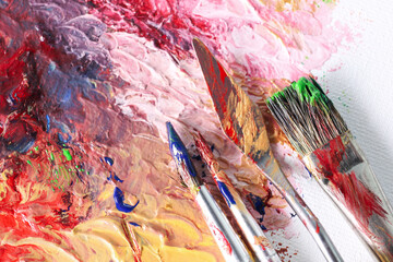 Abstract colorful artwork and brushes, closeup view