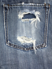 Close up detail of old torn denim jean, shallow depth of field
