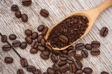 Instant granulated coffee with roasted coffee bean isolated on wood table background. 