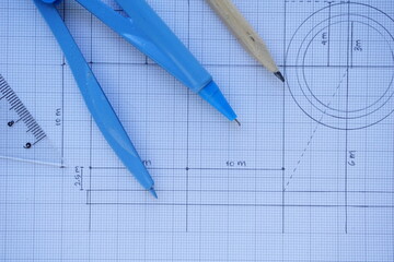 Close-up of Architect engineer drawing plan on blueprint with architect equipment. Architect Desk Top View with Drawing Plan, Drawing Compass White Background Copy Space