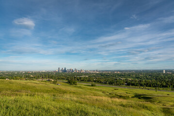View of Calgary and its downtown skyline from Nose Hill Park during the evening. 