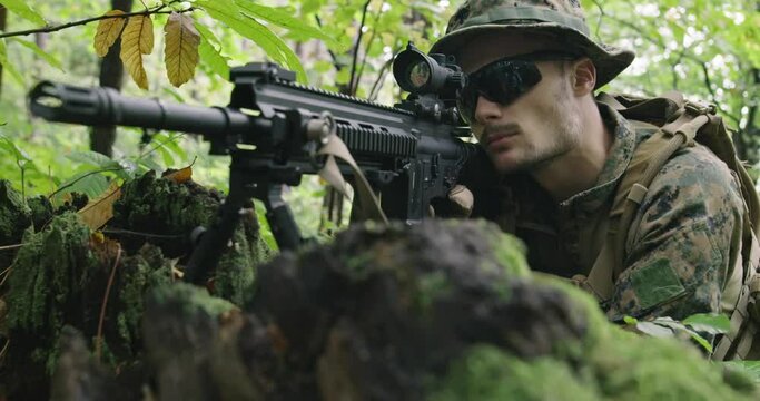 Soldiers or private military contractors aiming with rifle. war, army, weapon, technology and people concept