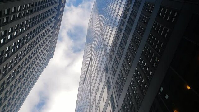 Reflective skyscrapers and high building view from below in slow motion