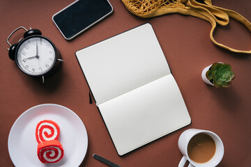 Breakfast in the morning and a book on brown table. Working at home concept. Copy space.