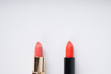 Two Beautiful red lipstick in black slipcover and pink lipsticks in gold slipcover isolated on...