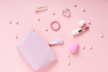 Cosmetic pink collection set on bright pink background.