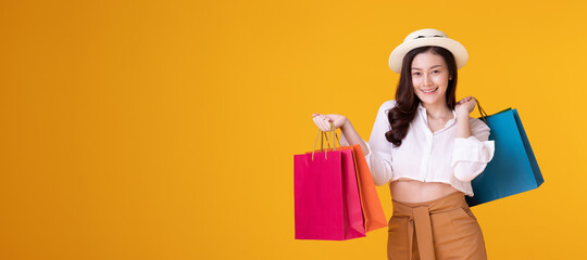 Happy asian woman holding shopping bag with mid year sale.