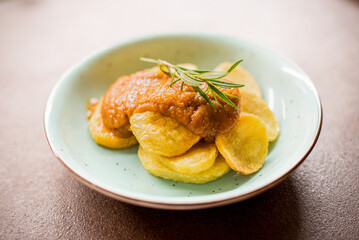 Potato dish with sauce on a white background
