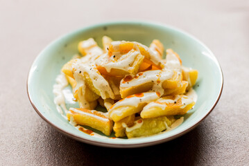 Potato dish with sauce on a white background