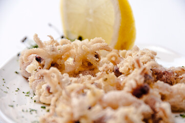 A plate of chipirones on a white background