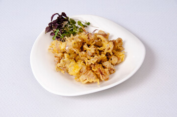 A plate of chipirones on a white background