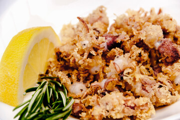 A plate of chipirones on a white background
