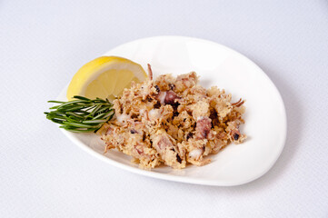 A plate of chipirones on a white background