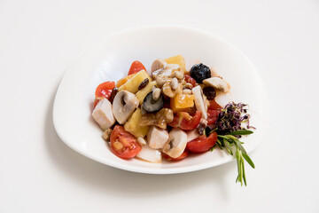 A plate of tomato and cheese salad on a white background