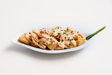 A plate of french fries on a white background