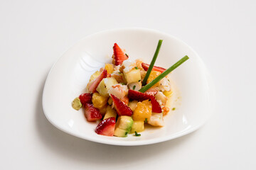 A plate of potato salad on a white background