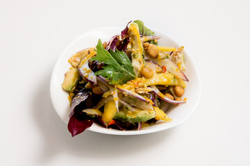 A plate of salad on a white background