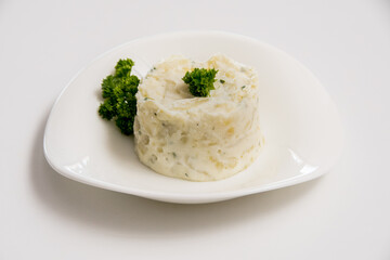 A plate of potato salad on a white background