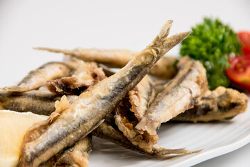 A plate of sardines on a white background