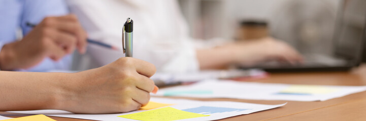 Close up hand woman take note and talk job in business meeting.