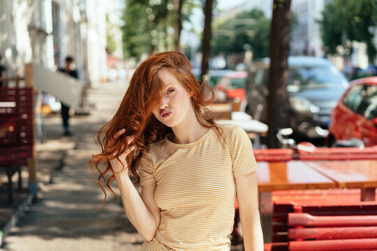 Young redhead woman pouting at the camera