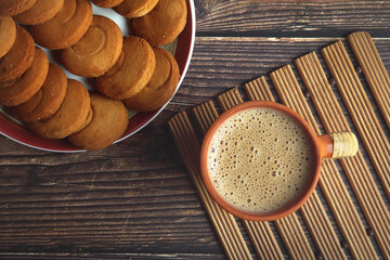 Cup of Tea on wooden table with Butter biscuits