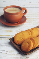 Cup of Tea on wooden table with Butter biscuits