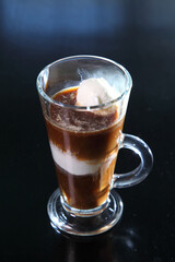 Ice cream coffee with a glass goblet with a pen.