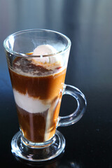 Ice cream coffee with a glass goblet with a pen.