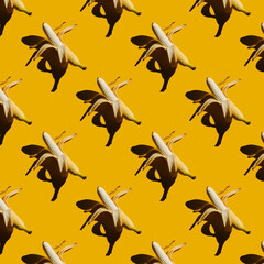 Yellow Banans Pattern on yellow Background. Wallpaper pattern with bananas. Fruit and food themes. Good for wallpaper, textile, background, poster, cover of book, post cards