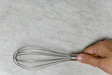 hand holding egg beater