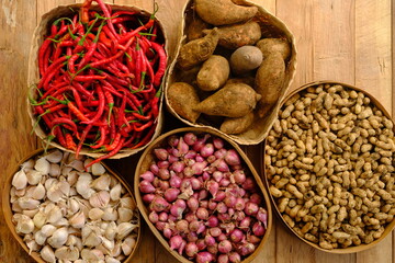 bawang, ubi jalar, kacang are shallots, garlic, red chilies, sweet potatoes, and peanuts in bamboo...