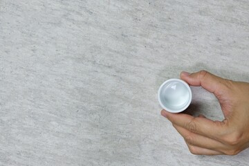 hand holding a white ceramic tea cup