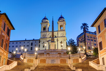 Fototapeta na wymiar The Trinita dei Monti church and the famous Spanish Steps in Rome at dawn