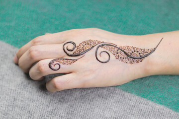 Woman Hands with black mehndi tattoo. Hands of Indian bride girl with black henna tattoos. Hand...
