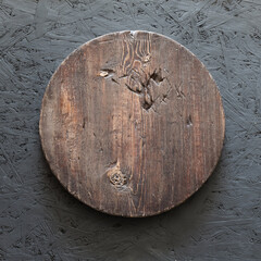 round wooden plate on old wooden background